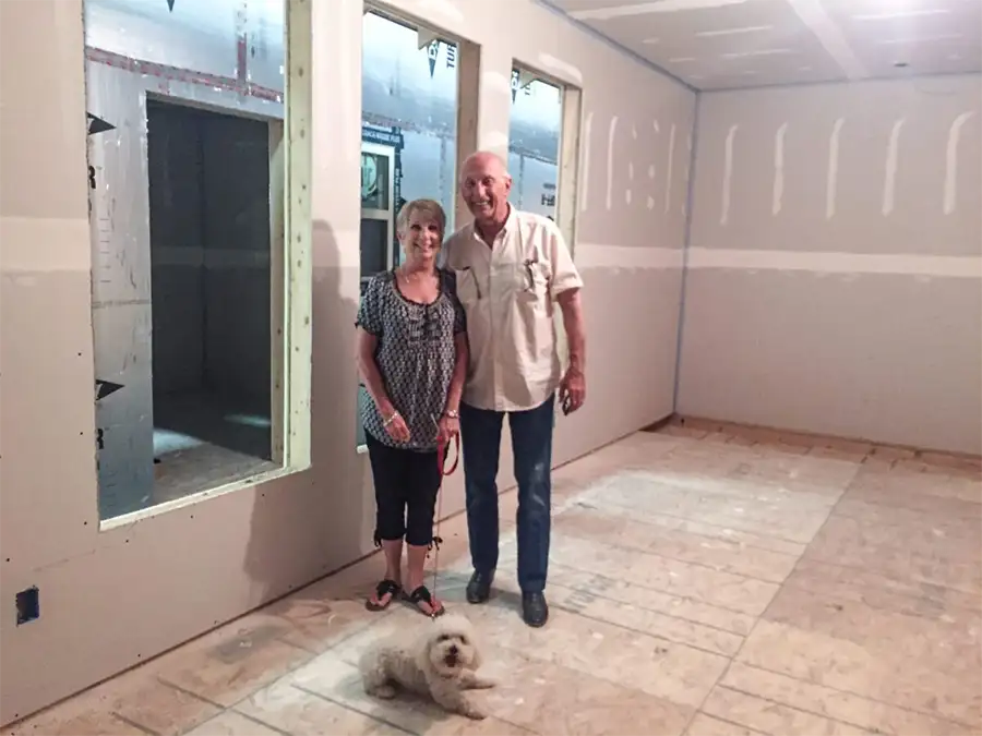 couple standing together inside home being built
